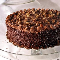 German chocolate cake presented on a glass cake plate... Moist, mouthwatering chocolate layer cake with traditional pecan and coconut icing.